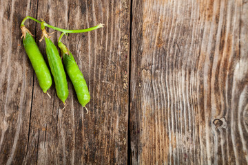 Green peas in a wooden bowl.