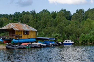 Naklejka premium Landscape with mountain meadows, forest, house and small wharf near artificial Vlasina mountain lake, South-eastern Serbia, Europe 