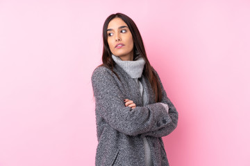 Young brunette woman over isolated pink background portrait