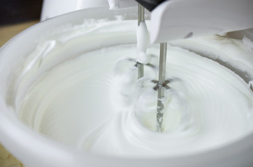 Close-up of a modern mixer making cream for making delicious pastries - 323956341