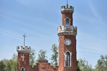 large and tall brick clock tower with blue sky background, with text space