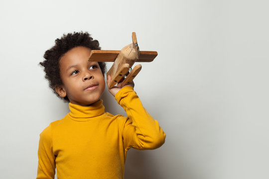 Playful Clever Black Child Boy With Plane Model