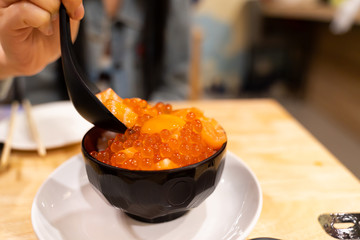 Salmon Roe Don In a Japanese restaurant Topped with egg yolk and salmon fillets