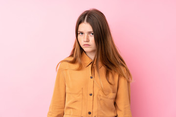 Ukrainian teenager girl over isolated pink background with sad and depressed expression