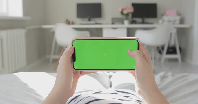 Women Uses Phone With Green Screen. Horizontal