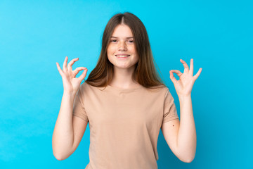 Ukrainian teenager girl over isolated blue background in zen pose