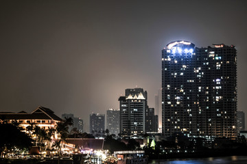 Obraz premium Business architecture, skyscrapers and light trails, Close shot of skyscrapers with lights, Night building. 