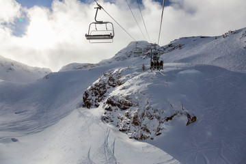 Fototapeta premium Whistler Ski Resort, British Columbia, Canada. Beautiful View of the snowy Canadian Nature Landscape Mountain and Chairlift going to the peak during a vibrant winter morning.