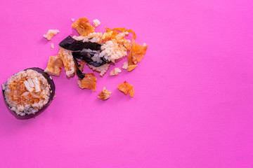 Smashed Kimbap on pink background. Top view. Conceptual picture.
