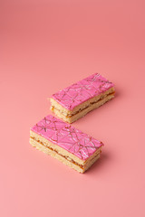 Traditional russian shortbread cakes with jam and pink glazing on bright background