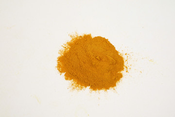 Turmeric extract powder on a white background is used as a tonic for the body and food ingredients.