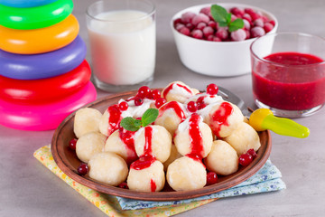 Children breakfast lazy dumplings with sour cream and berries