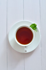 One small cup of tea with mint .