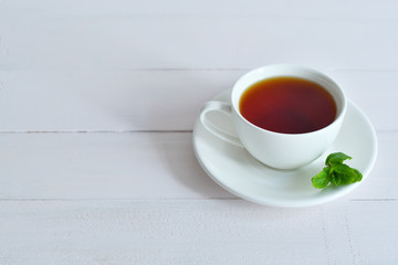 One small cup of tea with mint .