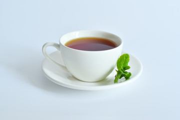 One small cup of tea with mint .