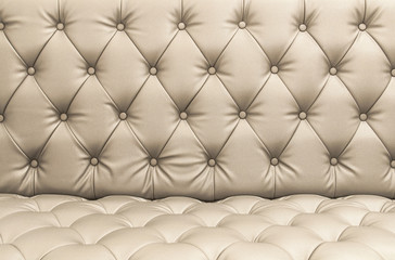 Closeup Light brown or beige color artificial leather texture of sofa.