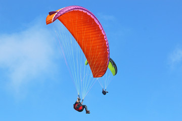 Paraglider flying wing in a blue sky	