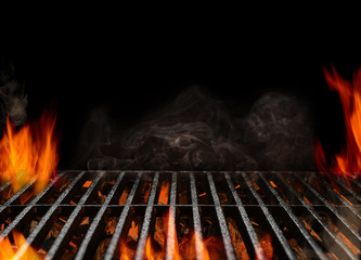 Hot empty portable barbecue BBQ grill with flaming fire and ember charcoal on black background. Waiting for the placement of your food. Close up - obrazy, fototapety, plakaty