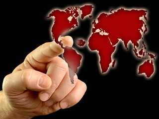 Index finger points to a map of the world. Finger touch in space. Man shows the geography of travel. Concept: tourism, adventure