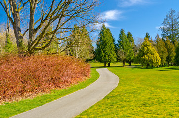 Beautiful golf course with gorgeous green and cart path.
