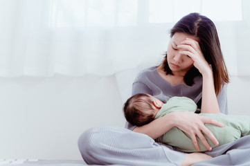 Tired Mother Suffering from experiencing postnatal depression.Health care single mom motherhood...