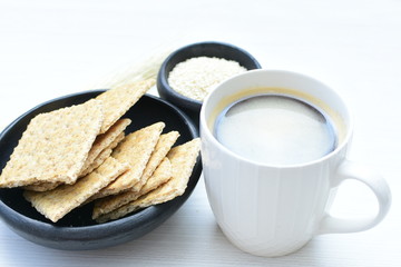 Healthy sesame biscuits (Sesamum indicum) healthy whole grain honey cereal and coffee cup