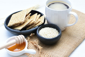 Healthy sesame biscuits (Sesamum indicum) healthy whole grain honey cereal and coffee cup