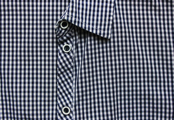 Formal business clothes classic blue and white blouse close up top view. Squared checkered pattern on unbuttoned stylish unisex shirt. Elegant long sleeve blouse detail 