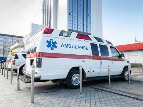 Image of ambulance cars on the parking at big modern hospital