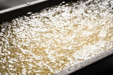 Cooking delicious french fries in hot oil, closeup