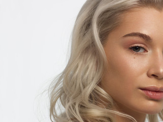 Fototapeta premium Closeup of half beauty woman with clean skin and natural cosmetics. Beautiful extrem eyelash and full lips of well-groomed girl demonstrate spa procedures, injections in a beauty parlor. Blonde hair