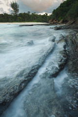 Fototapeta premium Waves and rocks shore long exposure