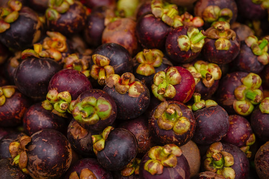 Fresh mangosteen fruits in market, top view pattern