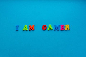 phrase "i am gamer" on blue paper background