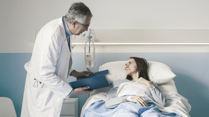 Obraz premium Doctor visiting a female patient at the hospital