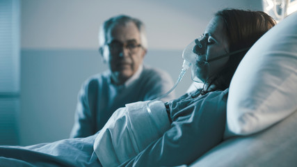 Man assisting her young daughter at the hospital