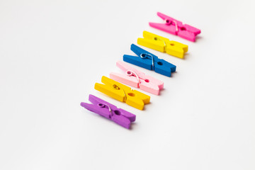 A row of wooden colorful clothespins