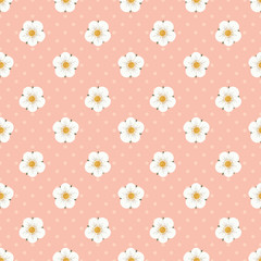 Seamless vector pattern with pretty strawberry flowers in white and yellow on a pink background with polka dots. Cute modern botanical design great for fabric, wrapping paper, party decor, gifts.