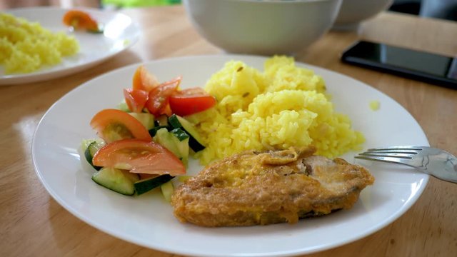 Powdered Curcumin Turmeric Rice With Fried Fish, Sliced Tomato And Cucumber Slices. Delicatessen Food. Eating Together Appetizer Concept