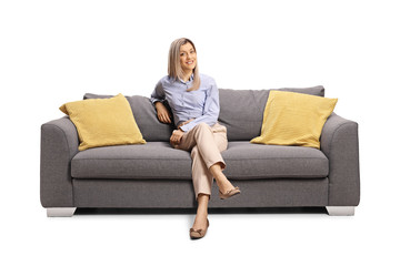 Young woman sitting on a sofa and smiling