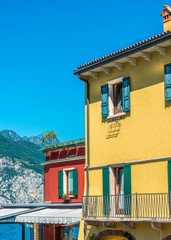 Fragment of a colorful apartment building in Malcesine, Lake Garda, Italy.