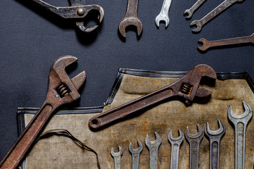 Vintage tool kit for repair and reconstruction at home lie on a black background