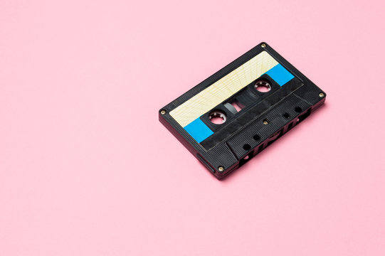 Retro audio cassette tapes on colorful background. Vintage music technology concept.