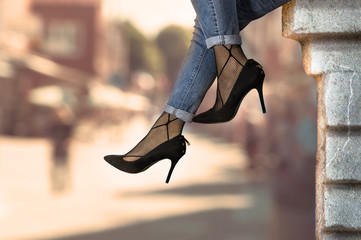 Woman legs in black high heel and jeans. Fashion and style.