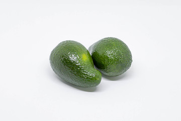 Two ripe avocados fruits isolated on white background with copy space for text or images. Fresh, raw, tropical fruit concept. Studio shot, close up