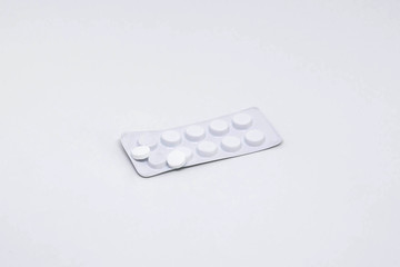 Pills on a white background. The cure for disease or epidemic. From a headache, cough, temperature.