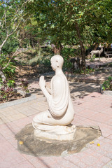 stone statue of a buddhist monk in the courtyard of the temple