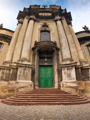 Fototapeta na wymiar Beautiful panoramic image of entrance door and stone stairs at the old dominican cathedral at Lviv, Ukraine