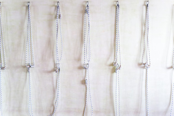 Yoga ropes hanging on studio wall. Iyengar yoga props