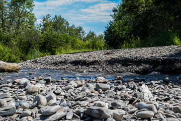 river with a stream and pebbles.pebbles at the bottom of the river